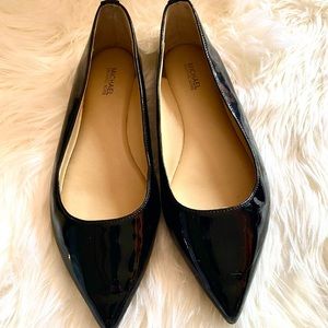 Black leather flats by Michael kors